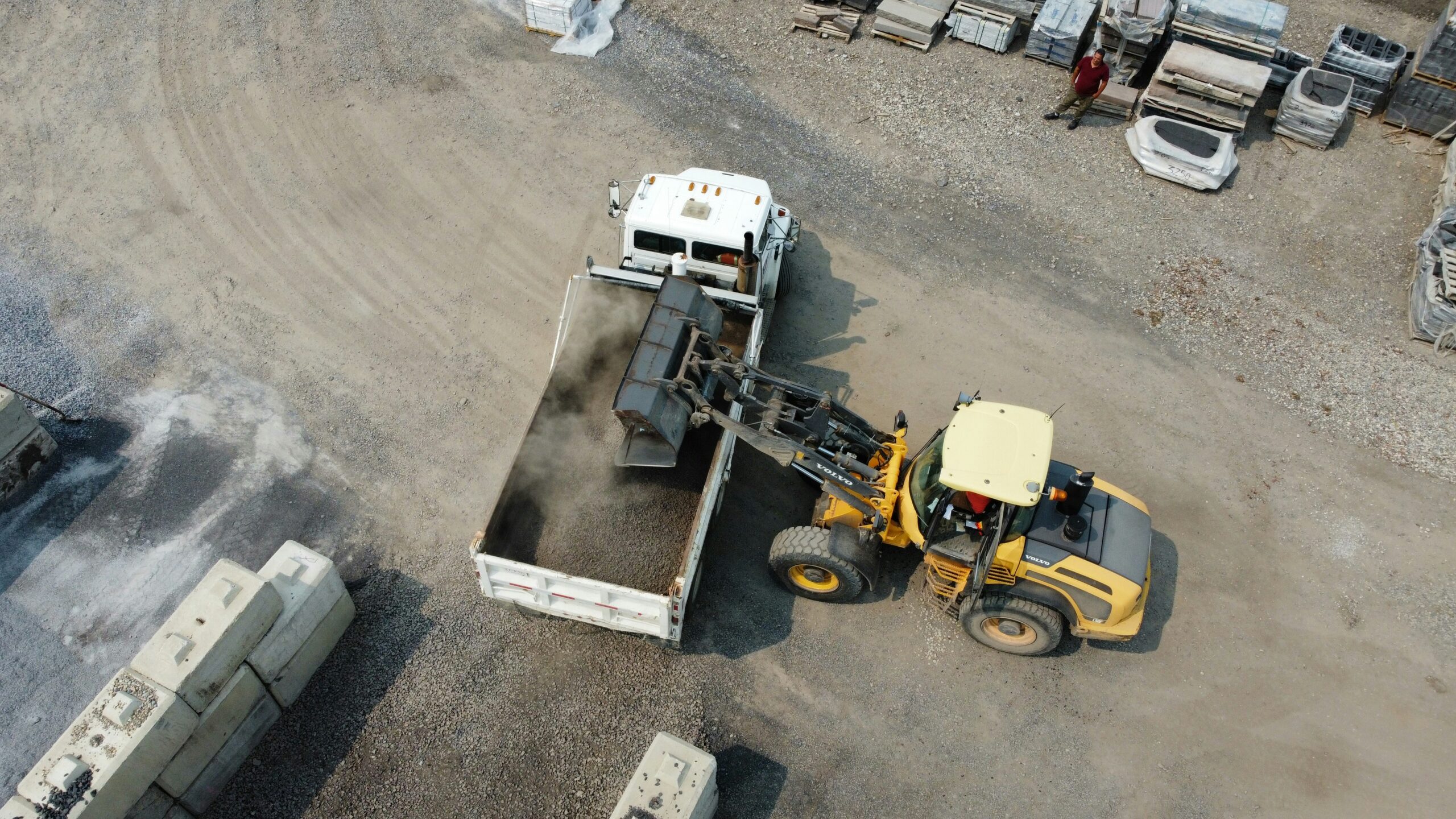 Forklift operator safely transporting materials through a warehouse aisle