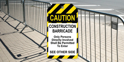 CAUTION construction barricade safety tag